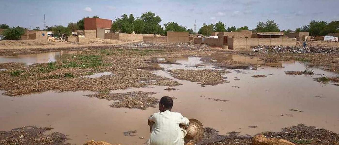 Hama Sorka, a fisherman from Niger, looks at the space where his house once stood before it was flooded by heavy rainfall in his neighbourhood