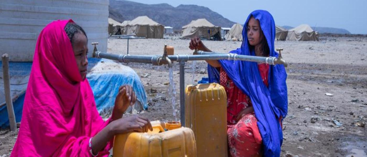 Thirteen-year-old Keria (left) fetches water at the Guyah site for internally displaced people in the Afar region of Ethiopia, which faces multiple humanitarian emergencies. This water point is part of a CERF-supported project of the United Nations Children's Fund (UNICEF) to provide children and families with life-saving assistance, 10 May 2022. ©UNICEF Ethiopia/2022/Zerihun Sewunet
