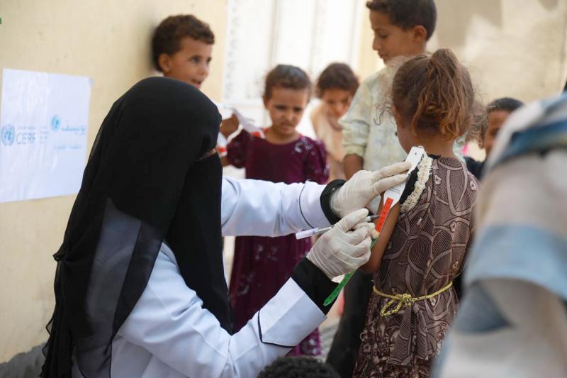 Dr Amna Al Mahdi screens a girl for malnutrition